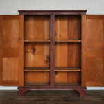 antique red two-door cupboard