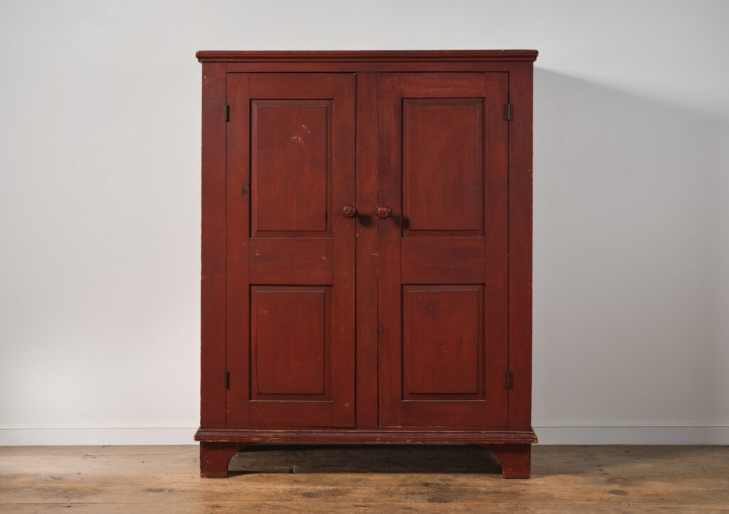 antique red two-door cupboard