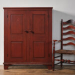 antique red two-door cupboard
